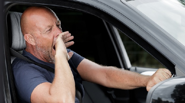 Man driving tired fatigue yawning