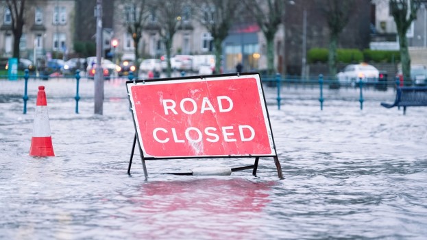 A road closed sign standing in a flooded road in Britain