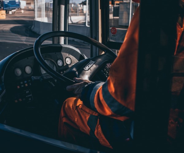 Man in PPE driving vehicle