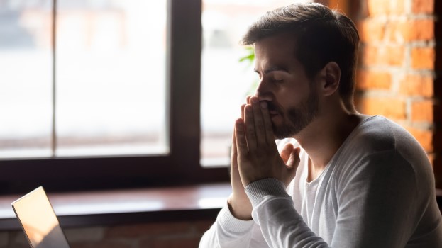 Man with his head resting on his hands