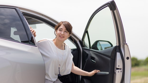 Woman opening a car door using the Dutch Reach technique