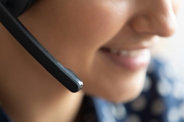 A woman's face and the microphone of a headset