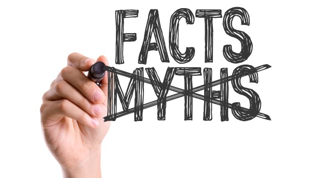 Hand crossing out the word myths and writing facts