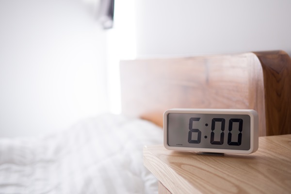 hotel-room-bed-with-alarm-clock