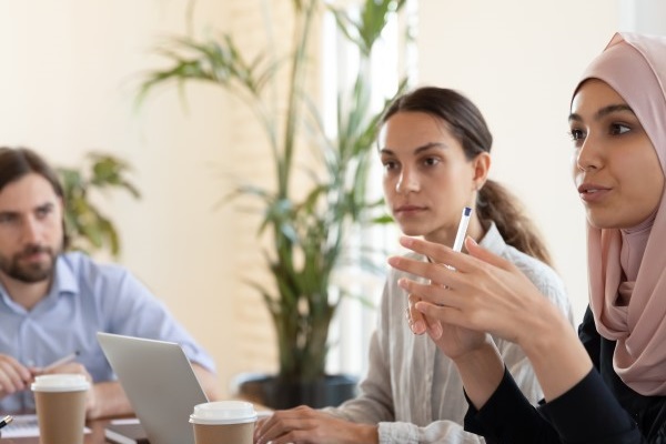 Group of colleagues at work talking and listening