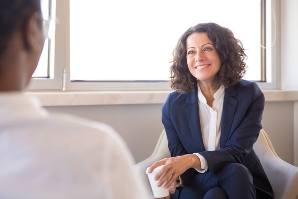 woman-in-suit-listening-with-coffee