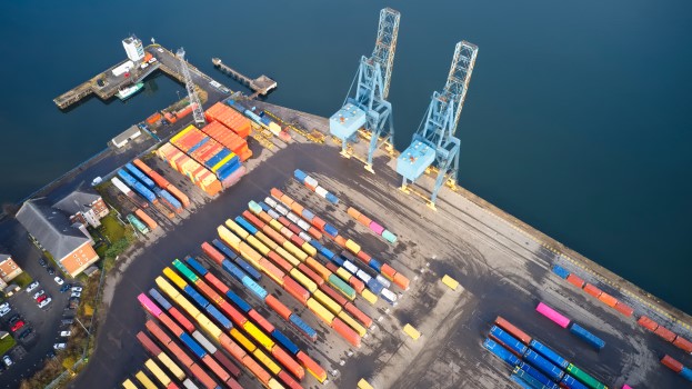Logistics port with cranes and shipping containers aerial photo