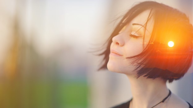 Woman deep in thought with eyes closed representing wellbeing