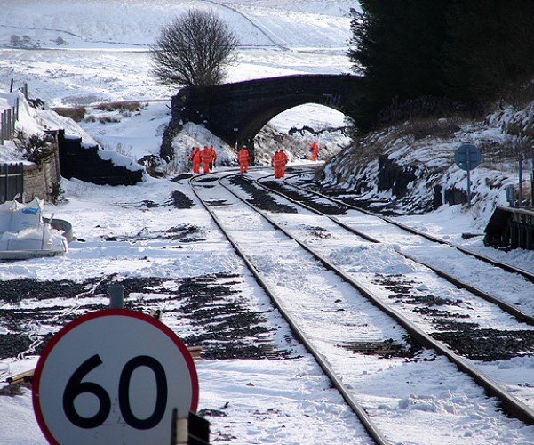 Trackside workers working in snowy conditions on the railway