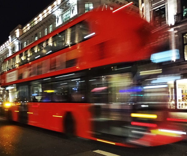 Blurry London bus in square