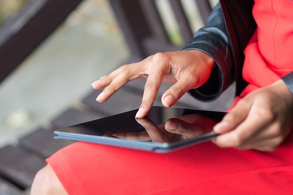 Close up of a woman using  a tablet